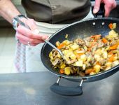 In the kitchen, the chef prepares his pan-fried food 