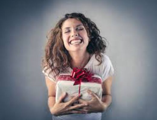 Femme souriante qui reçoit un cadeau 